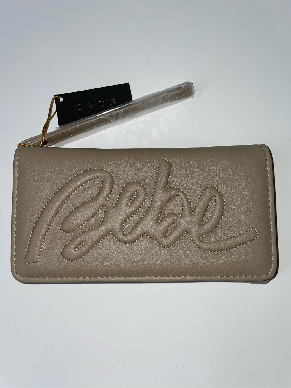 NWT bebe Taupe Louisa Trifold Wallet with handle strap.